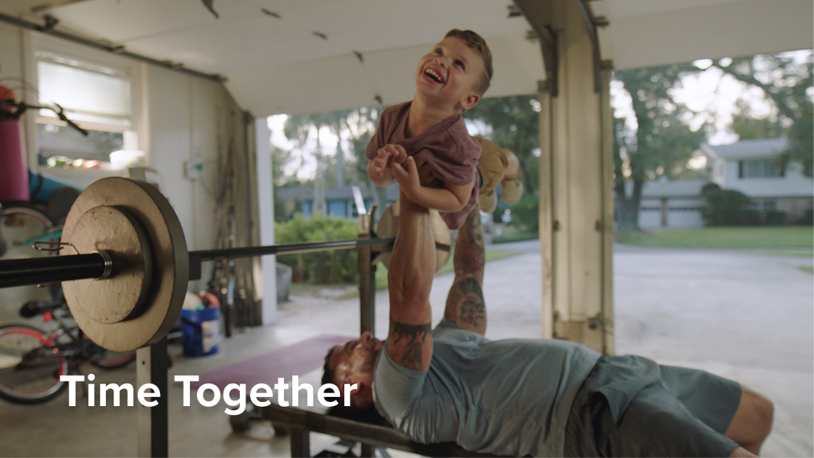 Dad benchpressing son